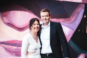 medium-shot--couple-infront-pinkish-graffiti