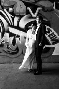 wide-shot-black-white-couple-infront-graffiti